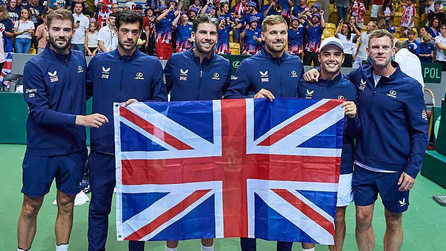 Great Britain's Davis Cup squad pose with a union jack flag after beating Poland