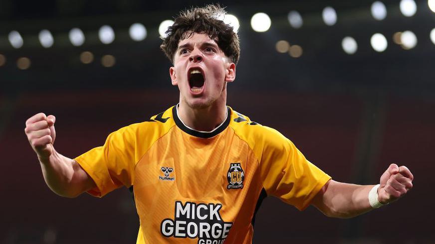 Cambridge United forward Glenn McConnell pumps his fists and screams in delight