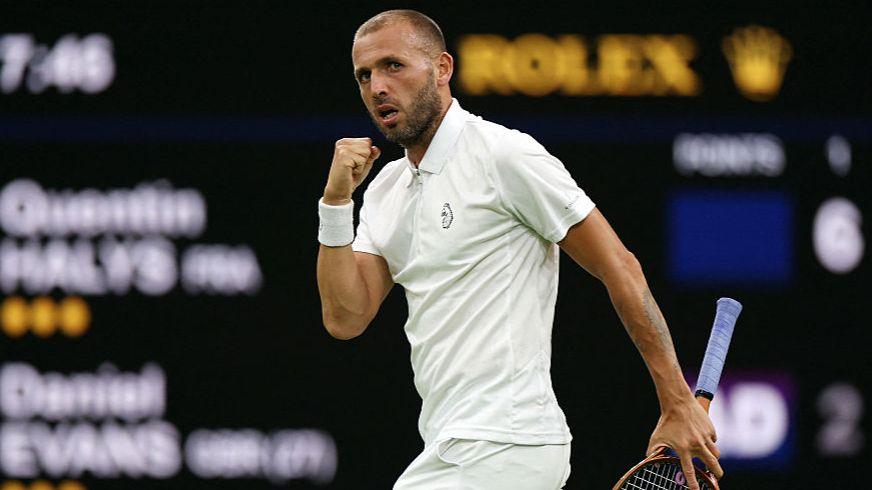 Dan Evans clenches his right fist during a match at Wimbledon