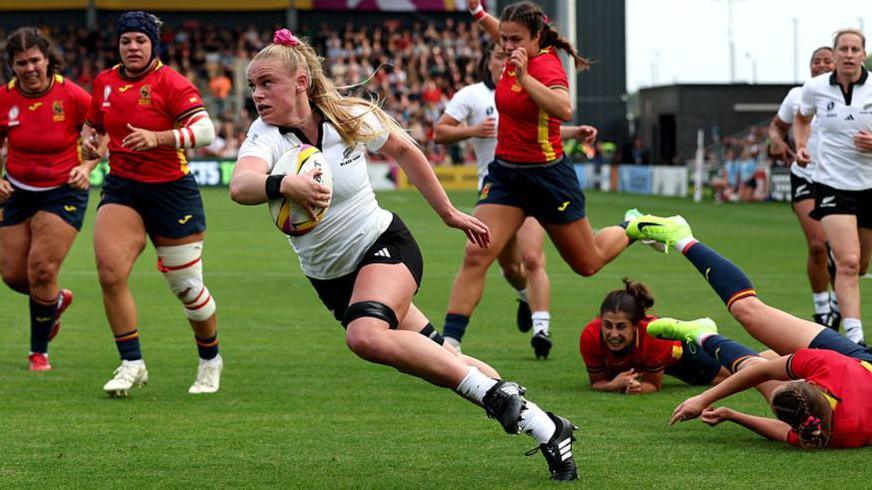 Jorja Miller blasts through Spain's defence to score the game's opening try