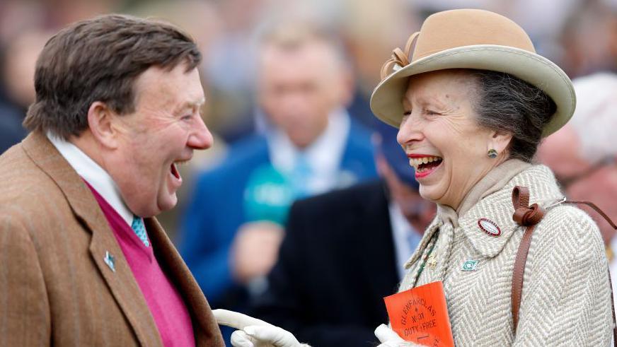 The Princess Royal shares a joke with leading trainer Nicky Henderson at the 2024 Cheltenham Festival