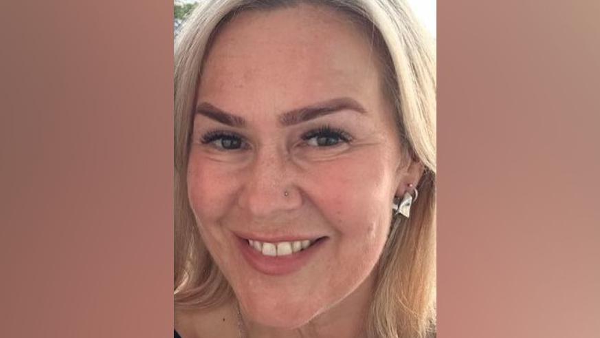 Close up of a smiling Helen Eadon-Sinkinson. She has long blonde hair