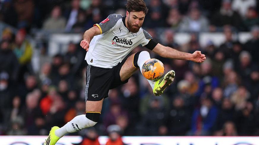 Derby's Ben Brereton Diaz jumps to control the ball