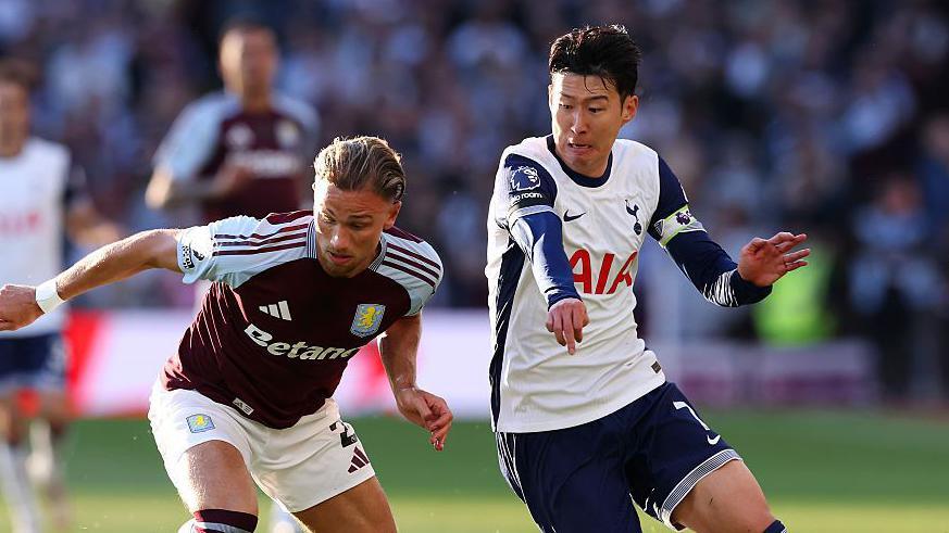 Son Heung-min challenges for the ball for Tottenham