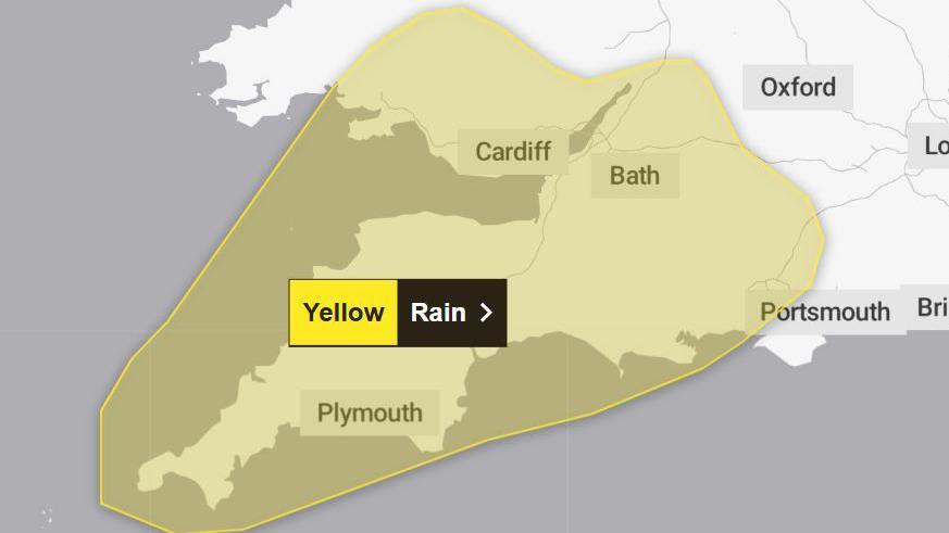 Graphic from Met Office website showing a weather warning for rain covering most of the South West of England along with parts of southern England and south Wales. The warning area is marked by a yellow blob.