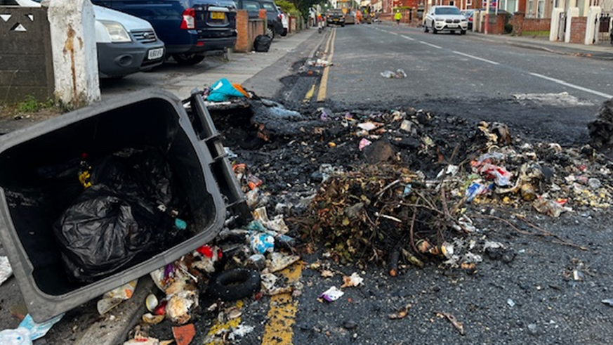 A overturned bin in the street after a night of violence