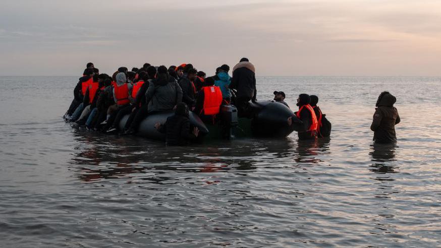 A migrant dinghy prepares to disembark from Gravelines, France