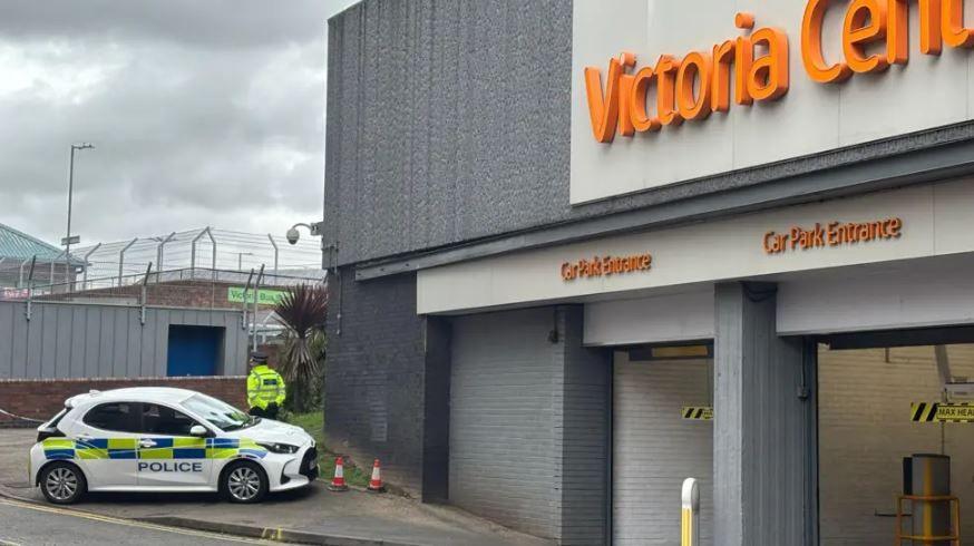 A police car and officer outside the Victoria Centre car park entrance