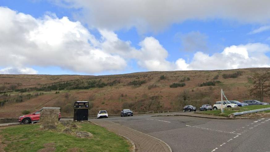 A care park under a blue and cloudy sky