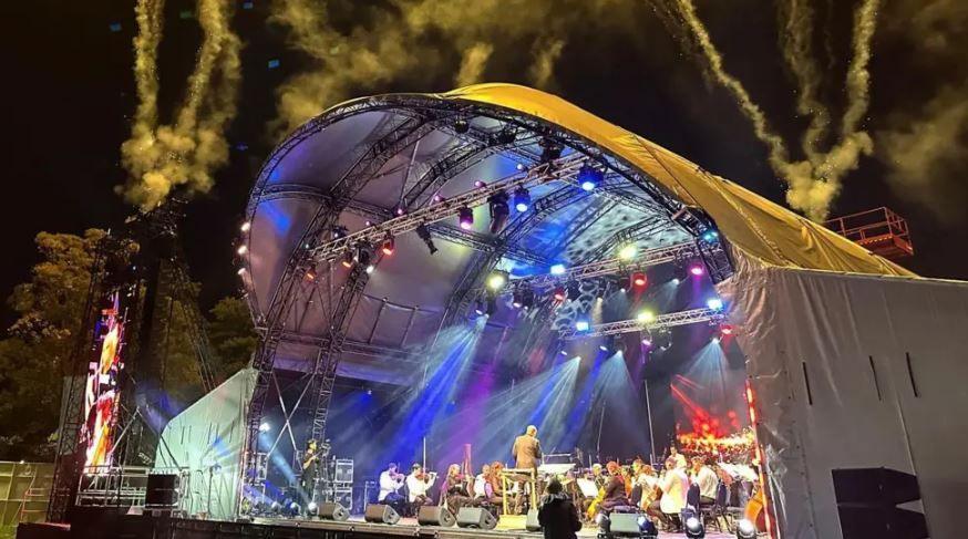 A stage at night with an orchestra playing.