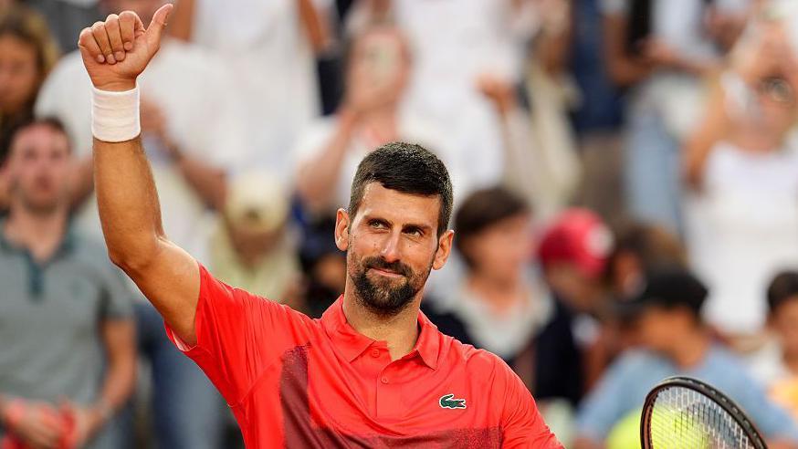 Novak Djokovic celebrates beating Corentin Moutet at the French Open