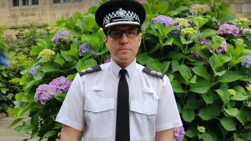 Ch Supt Daniel Greenwood. A bespectacled man in police uniform against the backdrop of a bush.