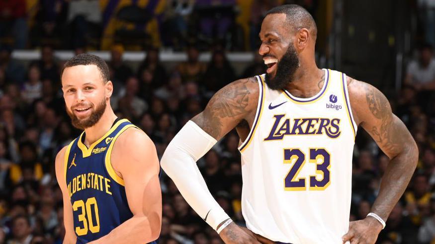 Stephen Curry and LeBron James smiling as the Golden State Warriors play the Los Angeles Lakers in 2024