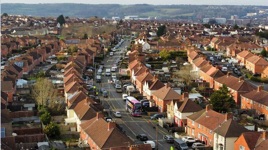 Aerial photo of houses in Knowle West. The road where Max Dixon and Mason Rist were stabbed is cordoned off by police and a number of officers wearing high-vis jackets are visible.