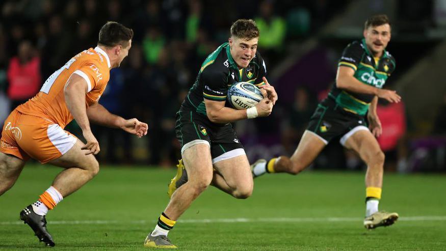 Northampton's Tommy Freeman takes on Sale's Tom Curry to set up a try for George Furbank