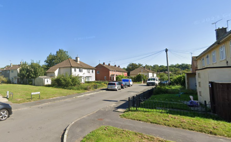 A wide shot of Westwood Road in Swindon showing houses and vehicles