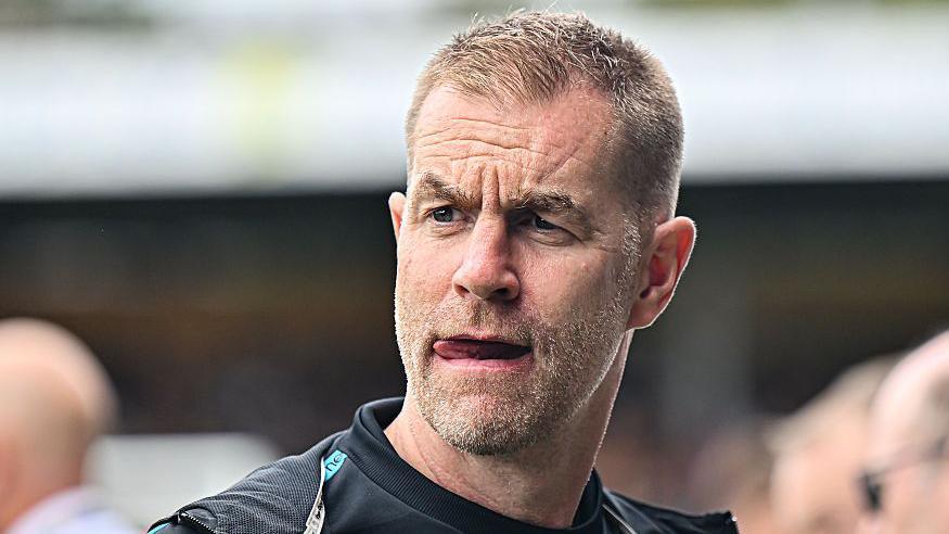 Harrogate manager Simon Weaver watches from the touchline