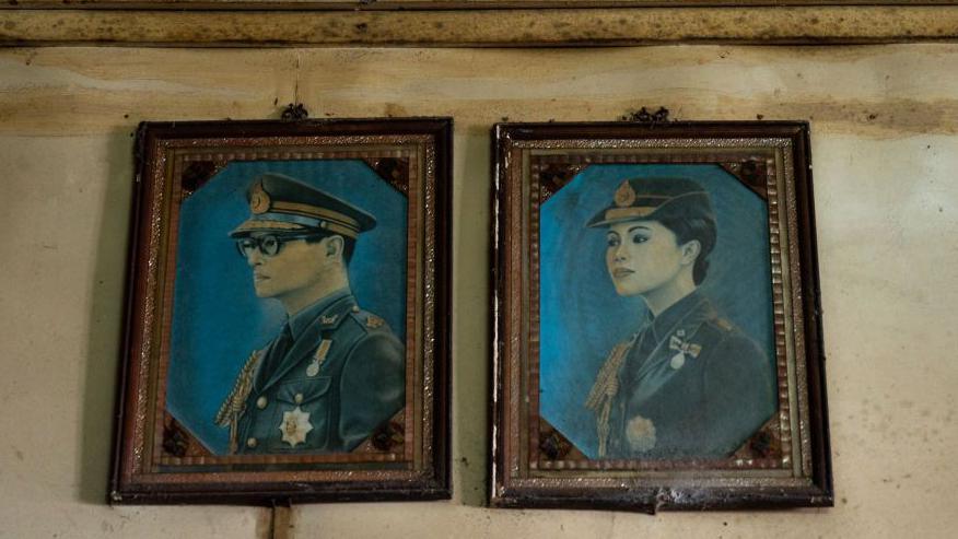 Portraits of King Bhumibol and Queen Sirikit in a Bangkok barbershop.