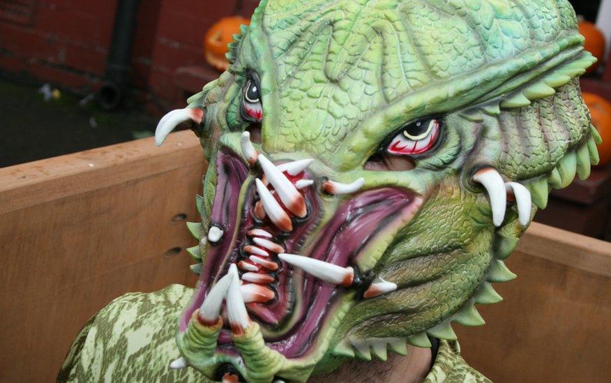 A close up of a man dressed in a green monster costume