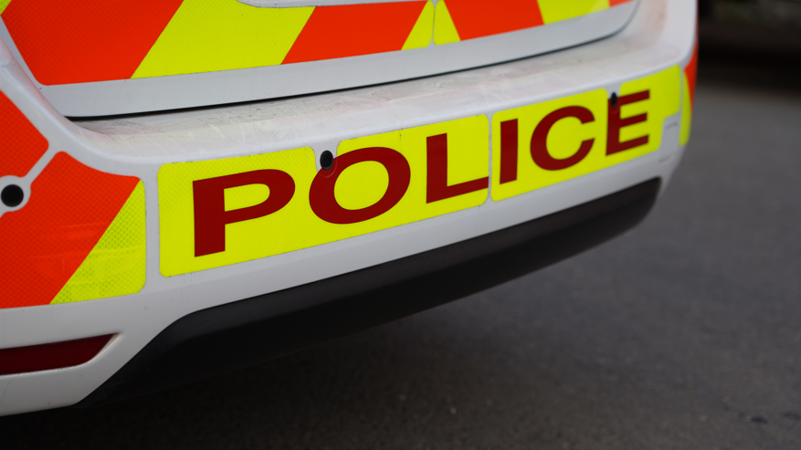 A stock image showing the rear of a high visibility police car