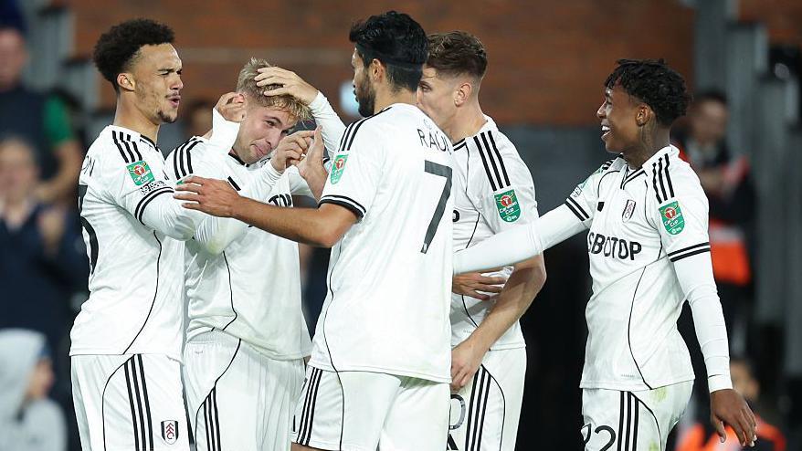 Fulham players celebrate Emile Smith Rowe's goal