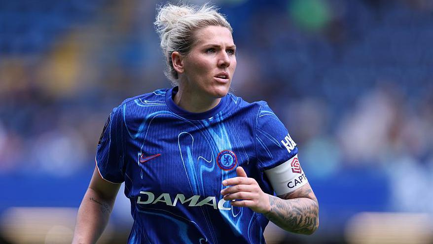 Millie Bright looking on