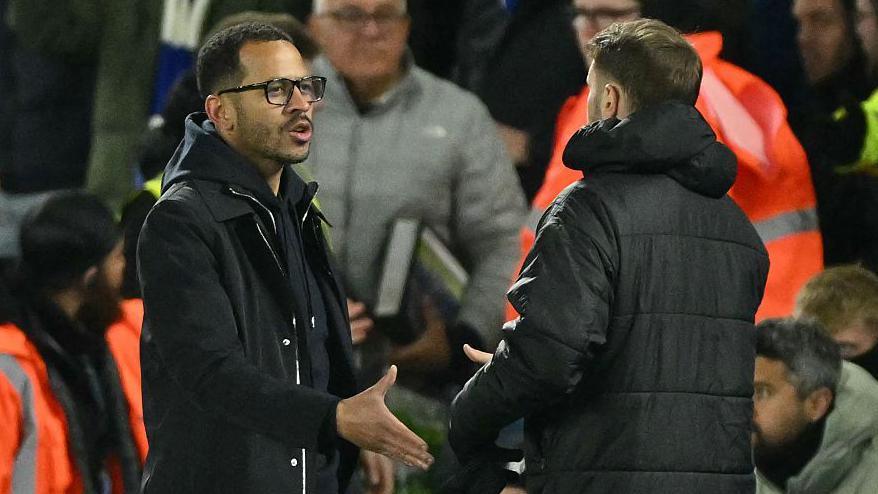 Liam Rosenior shaking hands with Fabian Hurzeler after losing to Brighton