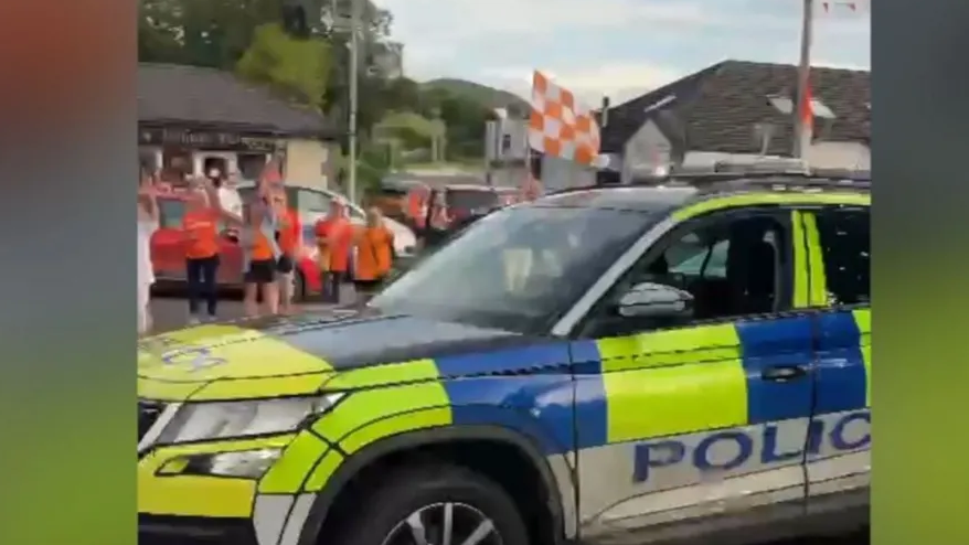 Still of video of PSNI car with Armagh GAA flags