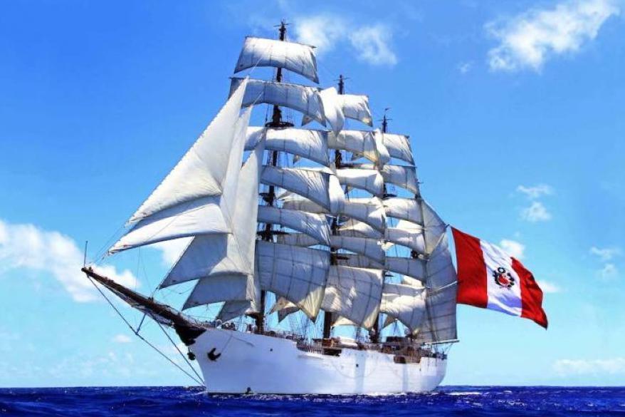 Tall ship - BAP Union - with white hull and sails, flying red and white Peru flag.