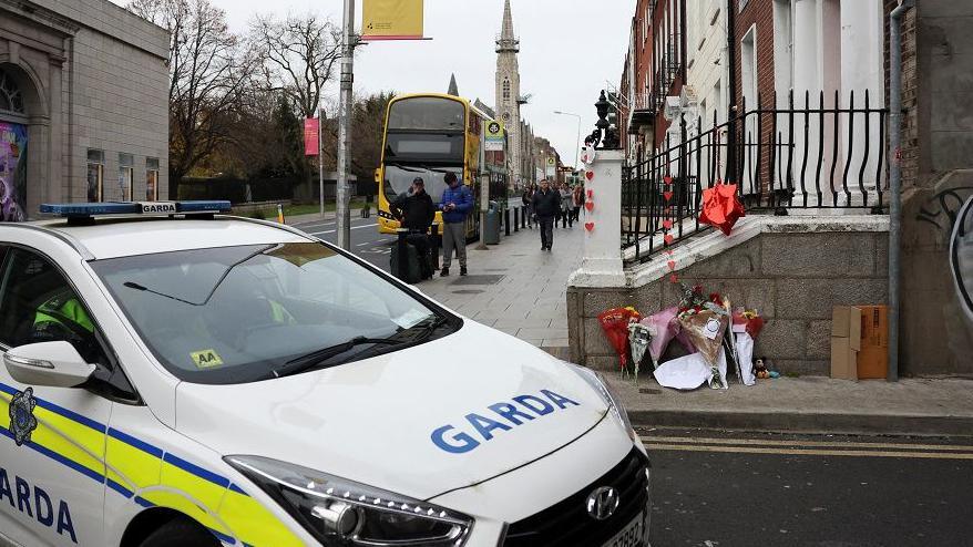 Floral tributes at the scene of the stabbing outside a Dublin school 