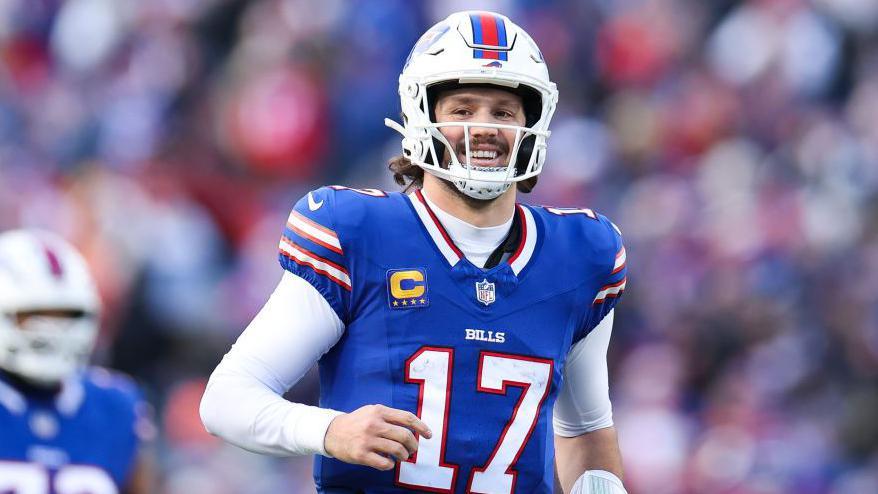 Josh Allen smiles after a Buffalo Bills touchdown against the Denver Broncos