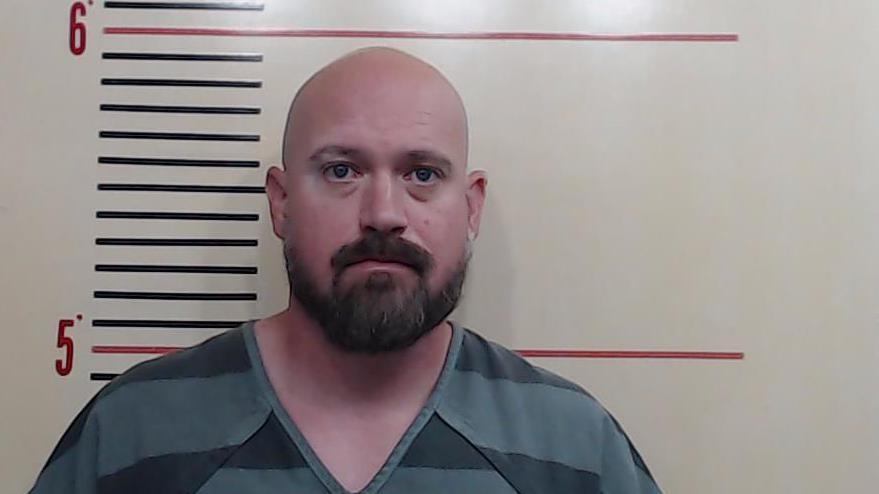 Justin Anthony Banta appears in a police mugshot 