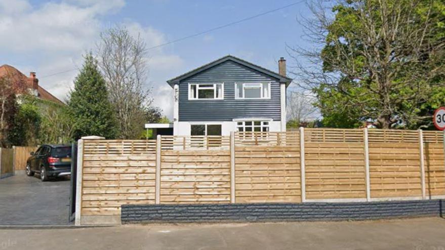 A house in Chepstow surrounded by a wooden fence