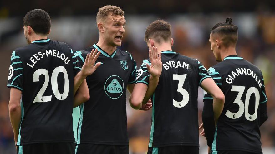 Ben Gibson organises Norwich City's defensive wall during a match