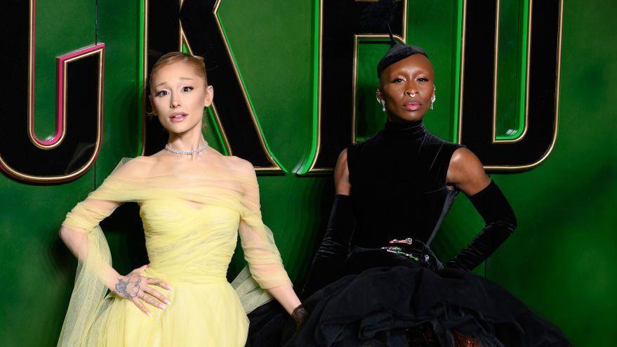 Ariana Grande and Cynthia Erivo against a green Wicked backdrop