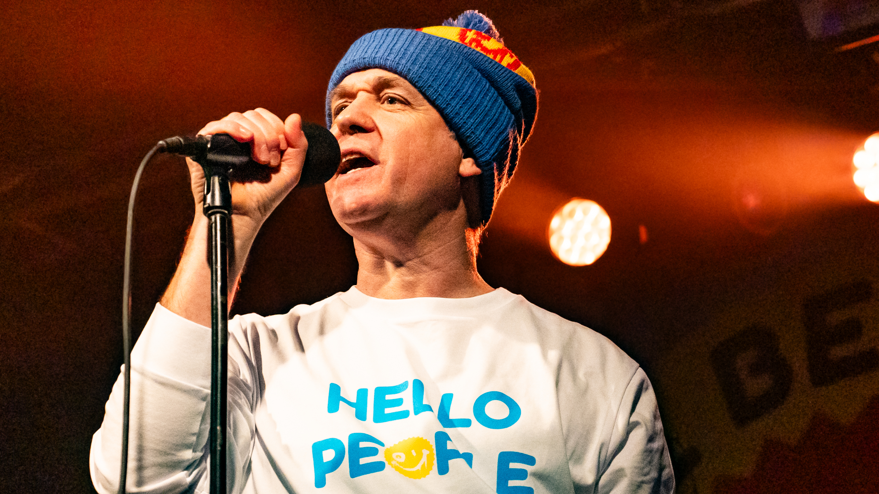 EMD singer James Atkin singing into a microphone