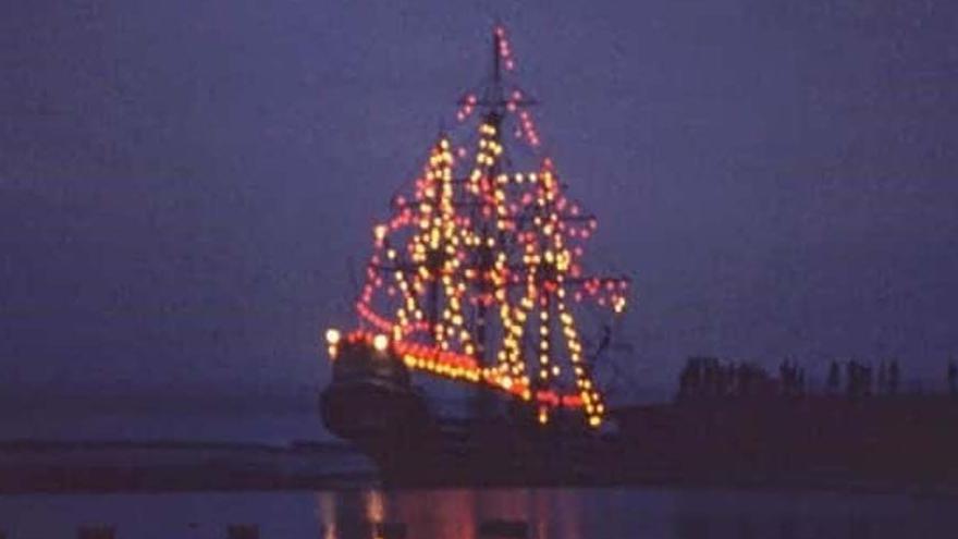 The slide shows an illuminated galleon on the water against a dark night sky