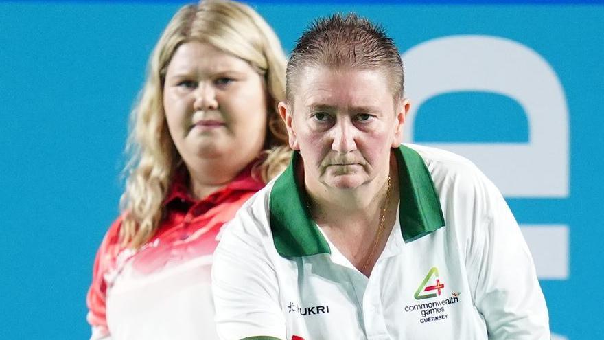 Alison Merrien bowls with Katherine Rednall in the background