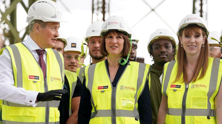 Rachel Reeves and Angela Rayner wearing high-vis jackets and hard hats on a visit to the Oval Village project in London 