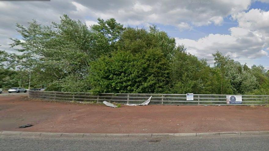 Signs can be seen on railings or falling off railings in the centre of the roundabout. 