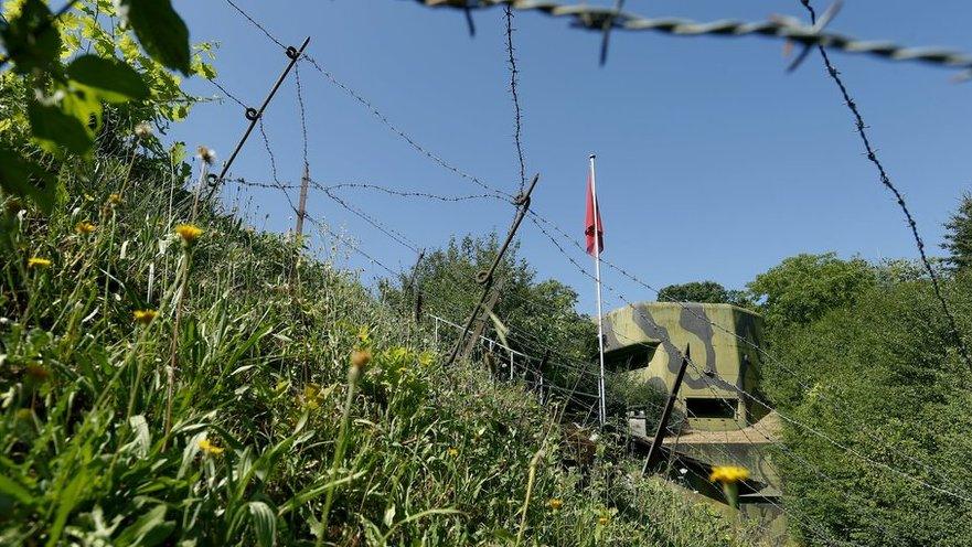 Barbed wire protects a bunker at former Swiss artillery fortress Reuenthal