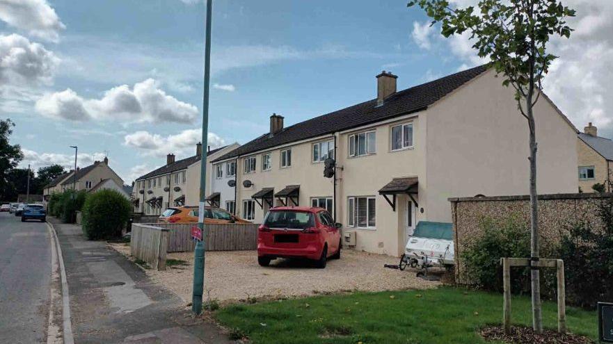 A row of eight semi-detached homes on Berkley Close. They all have driveways stretching out to the pavement