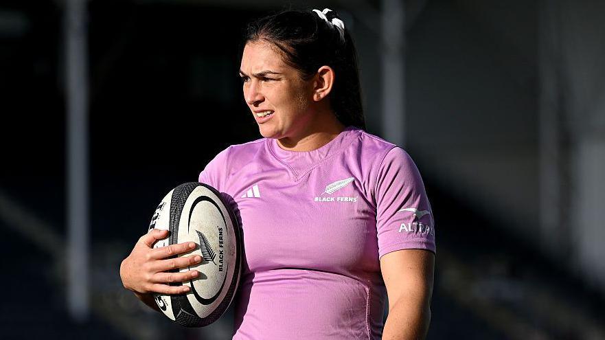 Georgia Ponsoby holds a ball in one hand while standing during a training session