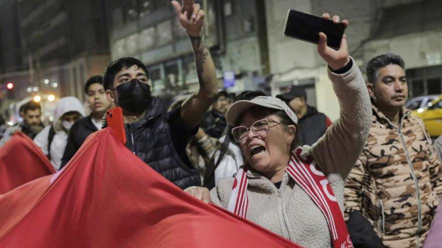 People react after Peru’s Congress voted unanimously to remove President Dina Boluarte from office in Lima, Peru.