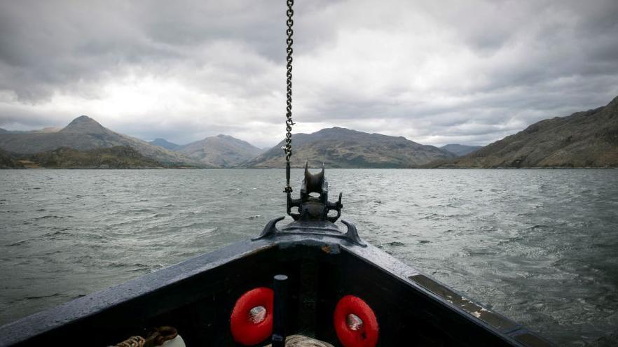 Looking out over the bow of a boat towards Knoydart