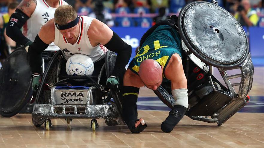 Aaron Phipps of Team Great Britain breaks past Chris Bond of Team Australia during the Bronze Medal match between Team Great Britain and Team Australia on day five of the Paris 2024 Summer Paralympic Games at Champs-de-Mars Arena on September 02, 2024 in Paris, France.