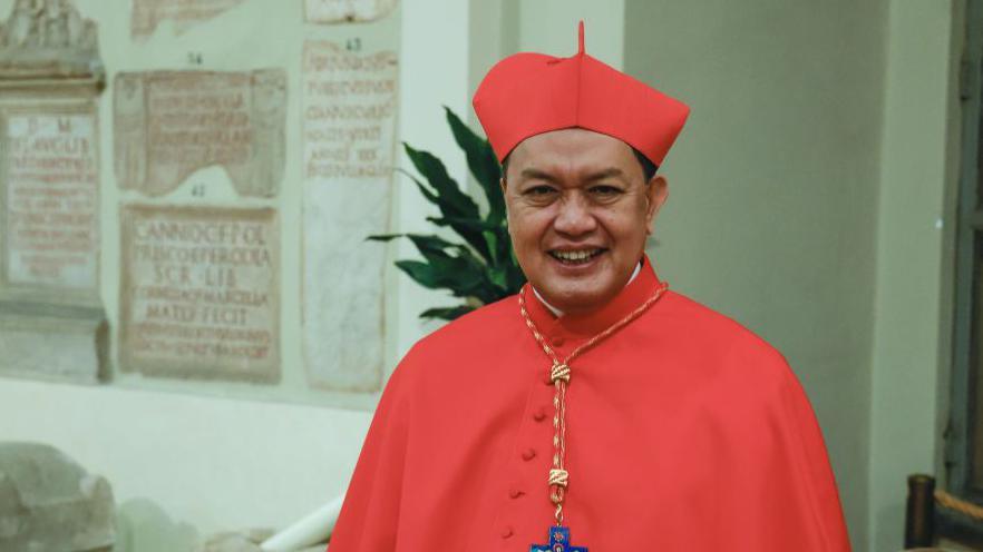 Pablo Virgilio Siongco David, Bishop of Kalookan, poses on being made a cardinal, dressed in a red cape