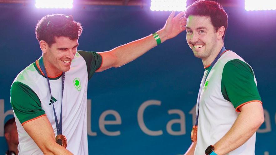 Philip Doyle (left) and rowing partner Dare Lynch displayed their bronze medals at the reception