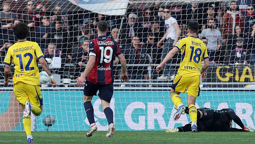 Hellas Verona's Kieron Bowie scores with Lewis Ferguson in pursuit