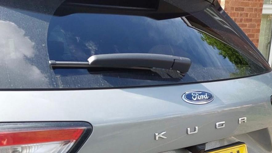 A photo of a silver Ford kuga zoomed in without a number-plate. 
 
